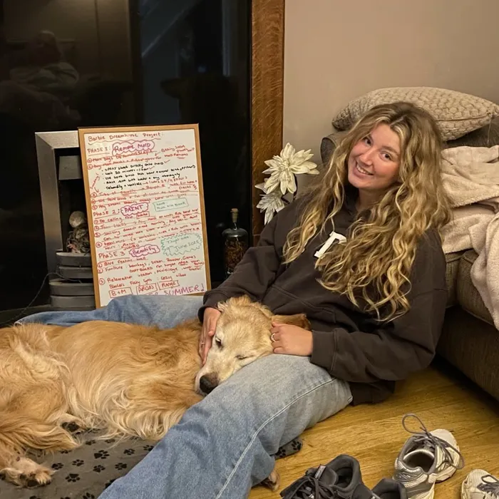 Barnaby resting on Lucy's lap at home
