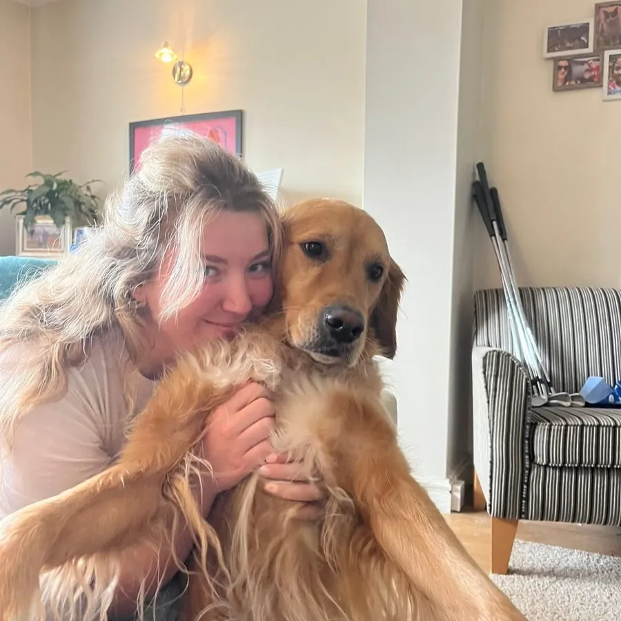 Lucy cuddling her golden retriever Barnaby at home