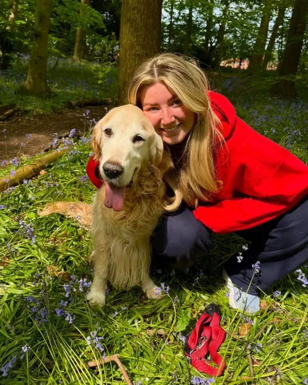 Lucy with a golden retriever among bluebells